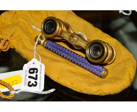 A PAIR OF LATE VICTORIAN/EDWARDIAN STYLE GILT METAL AND PURPLE ENAMEL OPERA GLASSES, marked Zingraff, Paris, with fabric stor