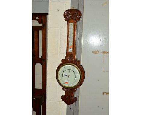 AN EDWARDIAN CARVED OAK ANEROID BAROMETER, height 86cm