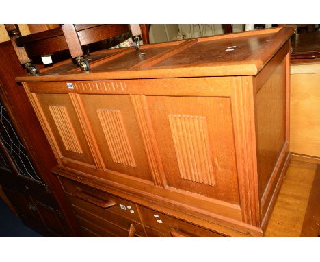 A LIGHT OAK LINENFOLD TRIPLE PANEL BLANKET CHEST
