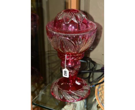 JOHN WALSH WALSH, a 1920's table lamp with a domed foot rising to a baluster stem and two piece shade, cased in ruby over cle