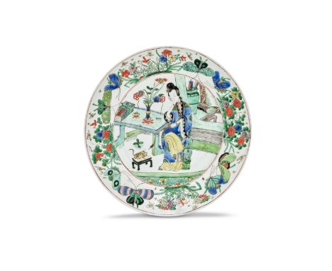 A FAMILLE VERTE 'LADY AND CAT' DISHKangxiEnamelled with a central roundel enclosing a seated lady in an interior playing with