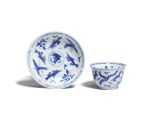 A MINIATURE BLUE AND WHITE 'FISHES' CUP AND SAUCERKangxiDecorated with fish amongst aquatic plants, with box.The saucer 6cm (
