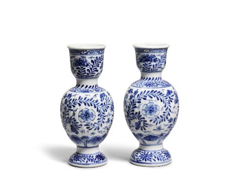 A NEAR PAIR OF BLUE AND WHITE CANDLESTICKSKangxiEach with a lightly ribbed globular body supported on a spreading foot and ri