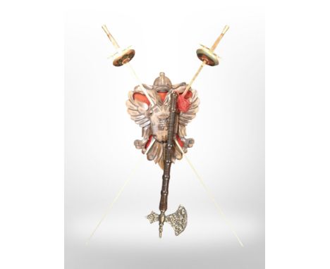 A pair of decorative swords on carved plaque, together with an ornamental hand axe 