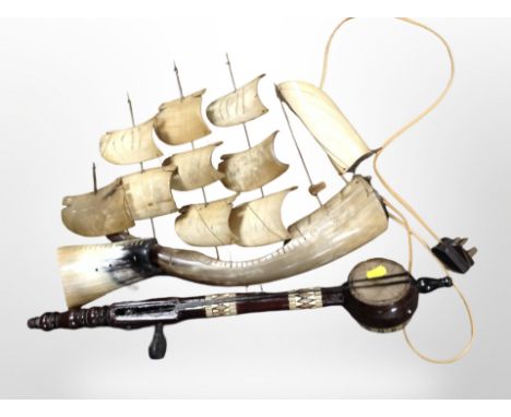 A carved horn model of a ship and a two-stringed instrument, length 56cm.