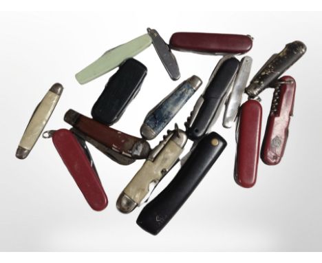 A group of folding pocket knives, Swiss Army knives, etc.