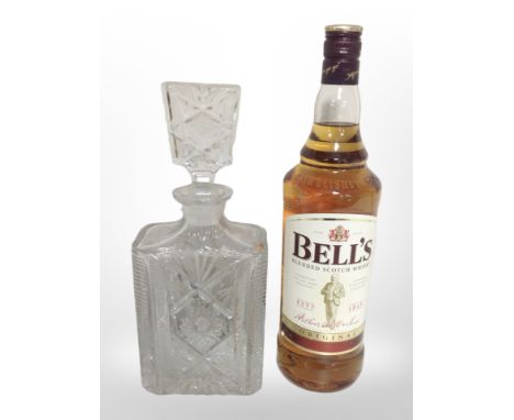 A bottle of Bell's Blended Scotch Whisky, 40% vol., 1 litre, together with a crystal decanter.