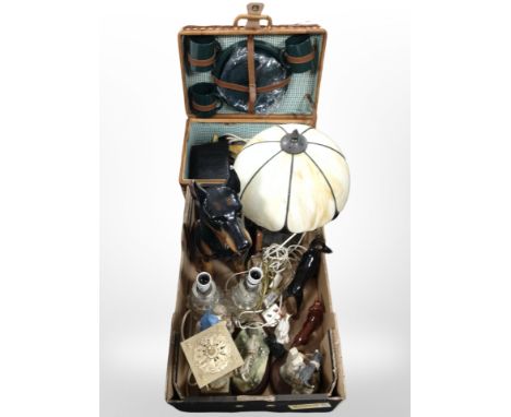 A wicker picnic hamper and contents, together with a group of lamp bases, figurines, Tiffany-style table lamp, ceramic figure