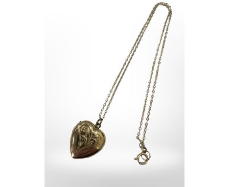 A 9ct yellow gold plated heart locket suspended on 9ct yellow gold chain