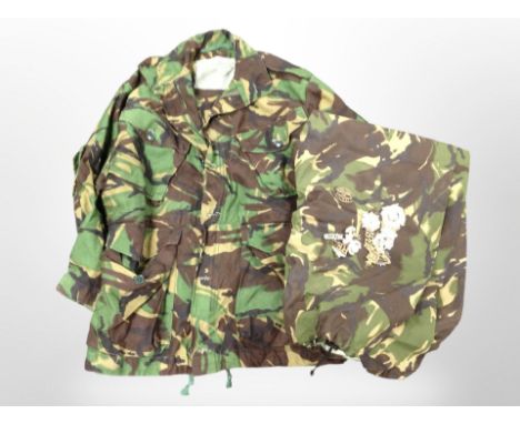 A DPM jacket and trousers, together with several army cap badges. (1 box)