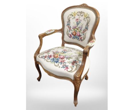A continental carved beech salon armchair in tapestry upholstery, width 62 cm 
