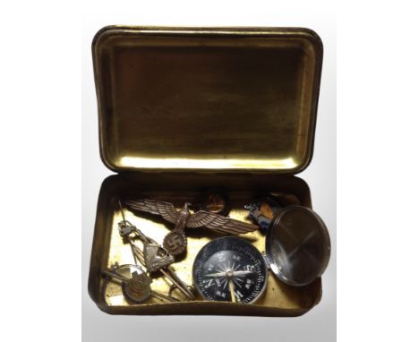 A Princess Mary brass Christmas 1914 tin containing enamelled badges, German cap badge, compass, etc.