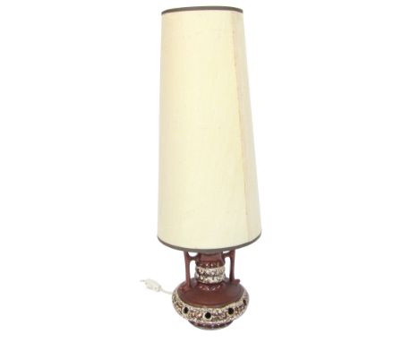 A German Fat Lava table lamp, the brown glazed and drill hole base, with a cream shade, 75cm high.