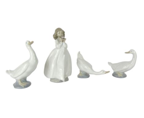 Four Nao figures, comprising three ducks, 15cm high, 12cm high and 11cm high, and a figure of a girl carrying flowers, No 144