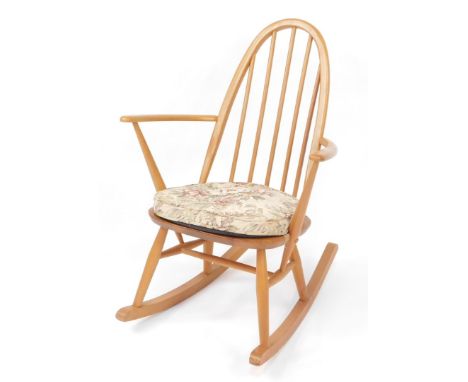 An Ercol light elm and beech rocking chair, Quaker model 428, with cushioned seat, 90cm high, 63cm wide, 70cm deep.