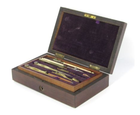 A late 19thC drawing instrument cased set, the top layer with multiple tools and a fitted and lined purple velvet interior, t