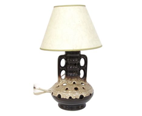 A German Fat Lava table lamp, with light and dark brown holed base, and cream shade, 63cm high.