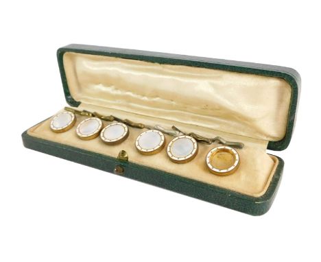 A Victorian cased collar set, with mother of pearl and white enamel detailing on a gilt finish, in a fitted case. (one AF).