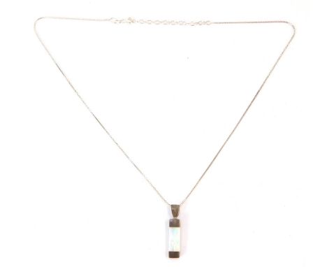 A silver opal Mackintosh design pendant, the single rectangular cut opal in tension setting, the pendant 3cm high, on a fine 