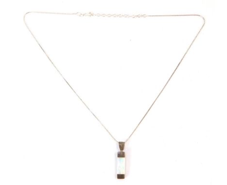 A silver opal Mackintosh design pendant, the single rectangular cut opal in tension setting, the pendant 3cm high, on a fine 