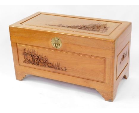 A light camphor wood chest, the top and sides with engraved Oriental figures, and brass buckle lock plate, raised on bracket 