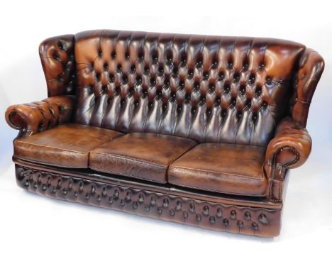 A brown leather Chesterfield style three seater sofa, with three drop in cushions and studded detailing, 120cm high, 193cm wi