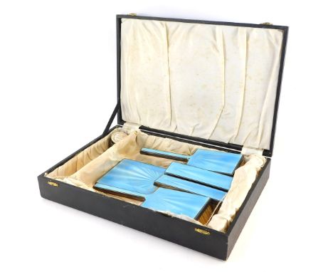 An Art Deco silver and blue enamel dressing table set, comprising four brushes and one mirror, Birmingham 1923, boxed. 