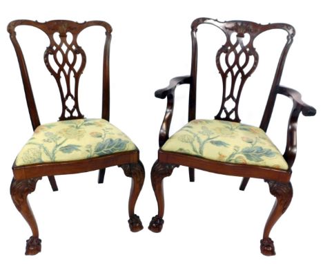 A pair of Chippendale style mahogany dining chairs,  with a pierced vase shaped splat, with drop in floral seats, raised on c