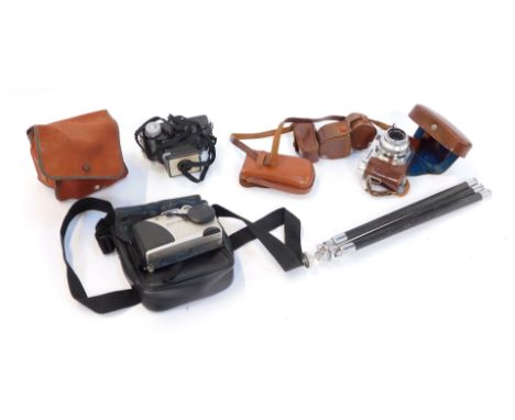 A group of cameras and equipment, a Voigtlander Veto B and flash, a Kodak wrapped in a duster, DC215 zoom and a Kodak Brownie