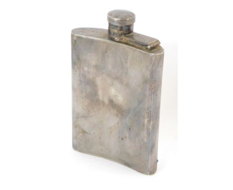 A George VI silver hip flask, of curvilinear form, with engine turned decoration, engraved to base 'To Robert from Grannie on