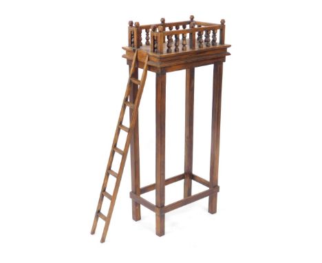 An Eastern mango wood bird feeding table, the galleried top raised on slender tapering square legs, united by a box stretcher
