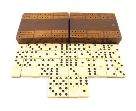 An early 20thC wooden cased travelling games set, with outer case cribbage board, opening to reveal a set of dominoes, 13.5cm