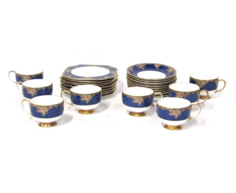 A Carltonware part tea service, comprising eight cups, ten saucers and nine side plates, each with royal blue and berry detai