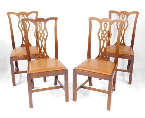 A set of four mahogany Chippendale style single dining chairs, each with a pierced splat, on H frame base, with tan leatheret