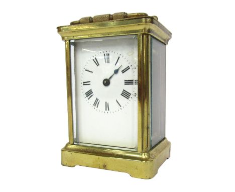 A brass cased carriage clock, the white enamel dial with Roman numeral chapter ring and single blue hand, in brass outer casi
