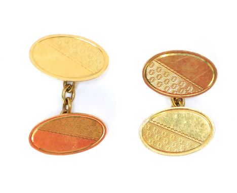 A pair of 18ct gold cuff links, each with oval engine turned decorated links, and chain links, 2cm wide, 9.8g all in.