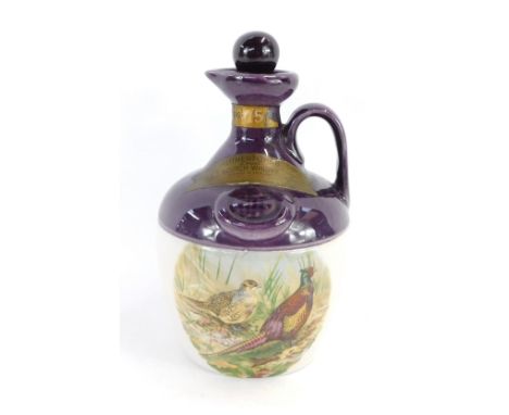 A Montrose Potteries Scotch Whiskey Decanter, the Rutherfords Blended Scotch Whiskey, with a purple glazed top, above pheasan