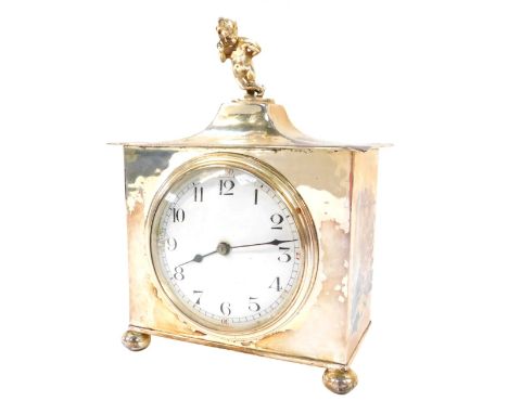 An early 20thC silver plated mantel clock, with timepiece movement, white enamel dial having black hands and Arabic numerals,