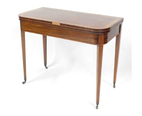 A George III rosewood and satinwood cross banded demi lune fold over card table, raised on tapering square legs, brass capped