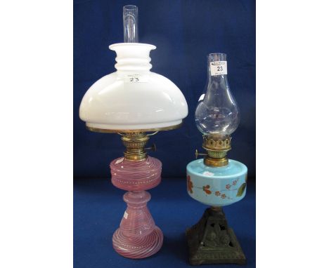 Mary Gregory type combed glass lamp base with brass burner, white shade and clear chimney, together with another single burne