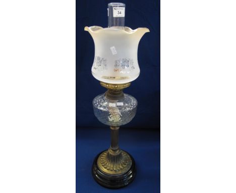 Early 20th Century brass double burner oil lamp with moulded glass shade on brass pedestal with ceramic base, etched glass sh