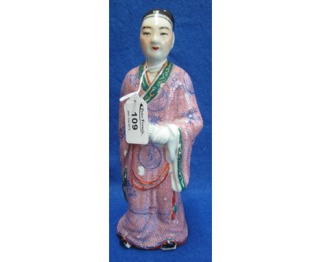 Chinese porcelain standing figure of a male courtier holding a scroll in his left hand.  Hand painted decoration with 4 chara