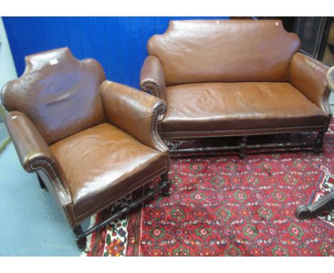 Early 20th Century leather three piece suite with stud work decoration, comprising two seater sofa and a pair of armchairs. (