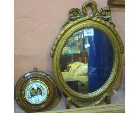 Walnut framed aneroid barometer of circular form, together with small oval gilt framed mirror. (2)(B.P. 24% incl. VAT)