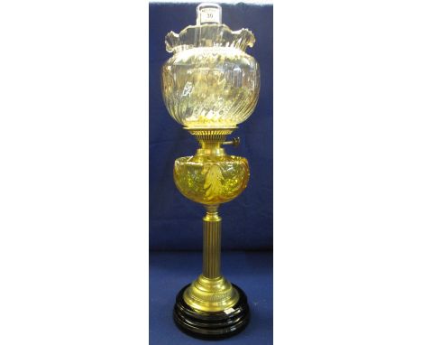 Brass double burner oil lamp with glass reservoir and brass pedestal with ceramic base, writhen iridescent shade and clear ch