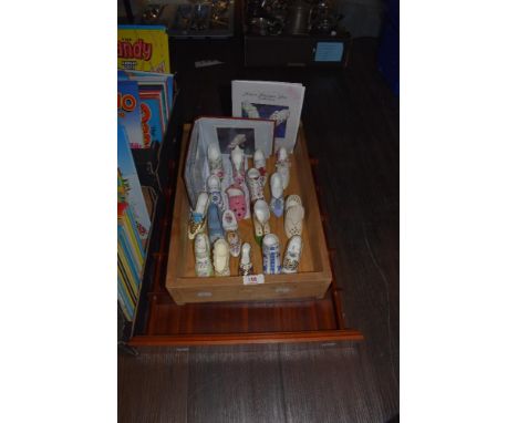 A Historic miniature shoe collection and a display shelf.