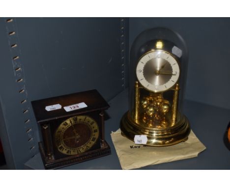 A mid century mantel clock and a small oak Smiths clock with brass face and Roman numerals.