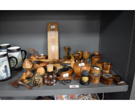An assortment of treen, including carved wood studies, games board, snuff box, puzzle and animal studies.
