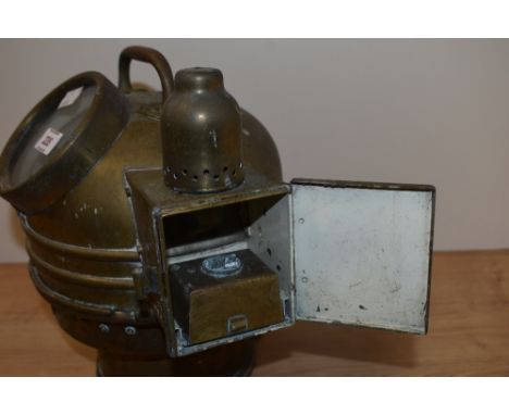 An early 20th century brass Binnacle housing compass, with casing for oil lighting to side.