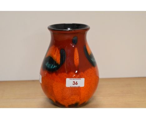 A Poole pottery vase, having orange, red and green lava like glaze.